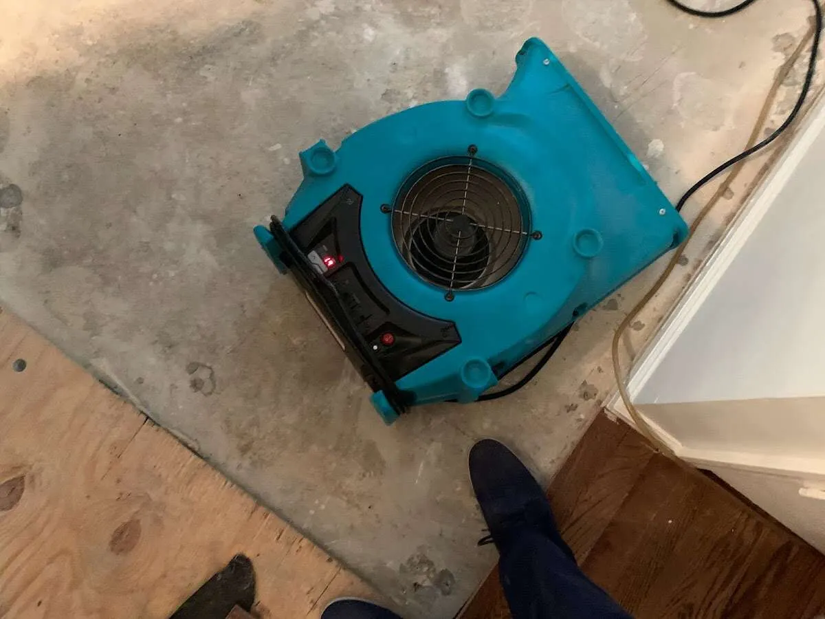Air mover drying subfloor during Commercial Water Damage Restoration in Chubbuck